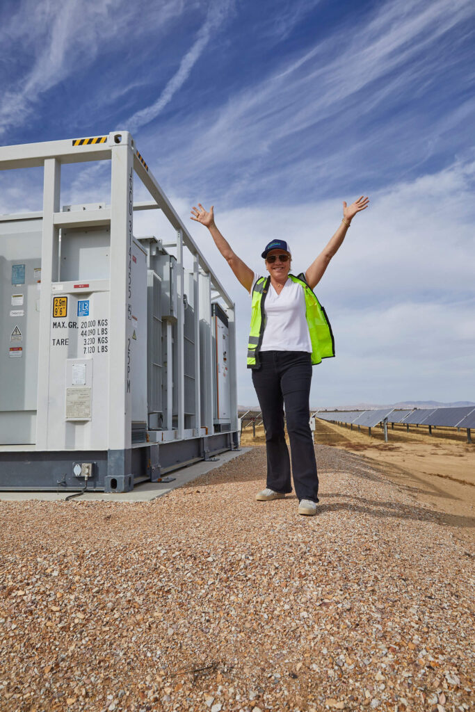 Shawn Marshall, CEO of Peninsula Clean Energy, standing near renewable energy power storage units at a solar facility.