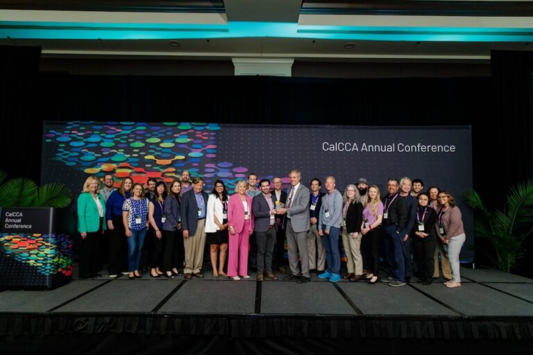 PCE staff receive an award on stage at the CalCCA Annual Conference