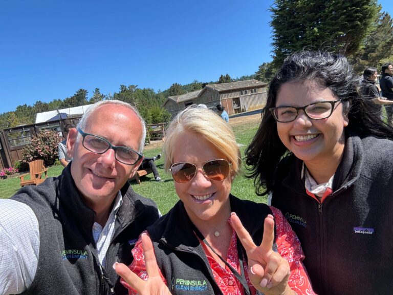 PCE's leadership team smile for the camera and hold up peace signs with their fingers