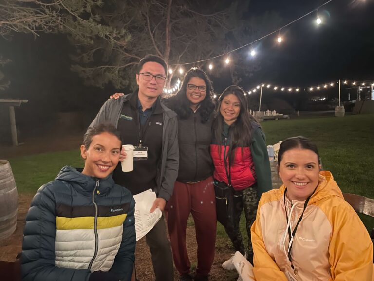 PCE staff gather together at night during a retreat at Costanoa