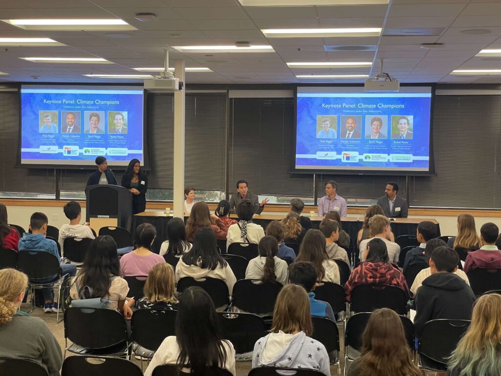 High school students attending a Youth Climate Ambassadors panel discussion featuring Rafael Reyes and other expert speakers, sharing insights on climate leadership and sustainability